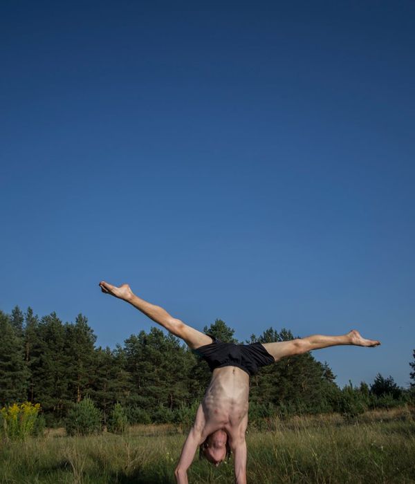 Man performing a controlled core stability exercise indoors.